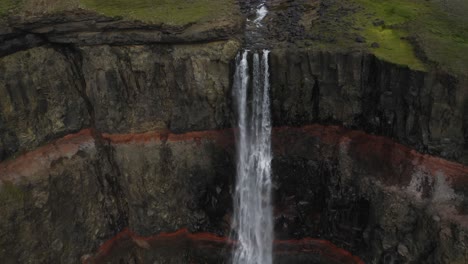 Cinematic-footage-of-idyllic-waterfall-crashing-down-into-volcanic-crater-ravine---Hengifoss-Waterfall-in-Iceland