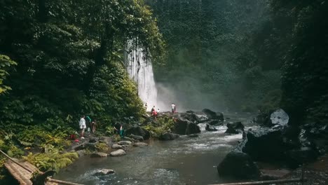 Bali,-Spring-2020-in-1080-60p,-Daytime,-cinematic-drone-flight-Long-slow-motion-backward-flight-from-waterfall-over-the-river-to-a-indigenous-bridge