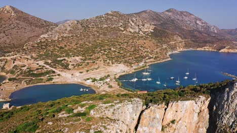 Aerial-Footage-Of-Rocky-Seashore-Of-Aegean-Turkey-And-Marina-With-Sailing-Yacht-And-Boats