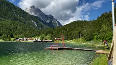 Lauter-Lake-in-summer-with-Obere-Wettersteinspitze-mountain-in-the-background,-very-close-to-the-bavarian-town-of-Mittenwald-in-Germany