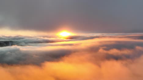 Sunset-video-over-the-clouds,-sun-paints-the-sky-orange-at-the-perfect-golden-hour-time