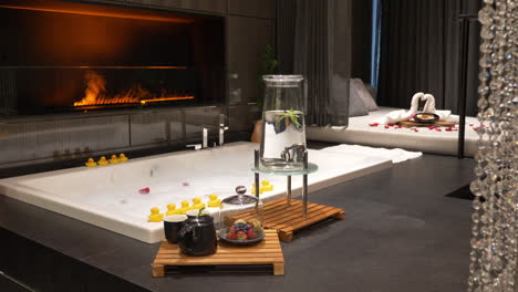 Honeymoon-Luxury-Hotel-Suite-with-Big-Bath-in-Front-of-Fake-Fireplace