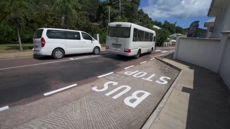 Public-bus-slowly-driving-past-bus-stop-in-Seychelles