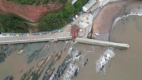Drone-Aerial-reveal-of-Lea-Mount,-Teignmouth-Hill,-Dawlish-with-beach-huts-and-pier