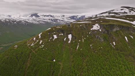Tromsø-Norway-Aerial-v16-drone-fly-around-mount-storsteinen-towards-upper-station-of-fjellstua-with-patches-of-melted-snow-on-mountain-during-early-summer-season---Shot-with-Mavic-3-Cine---June-2022