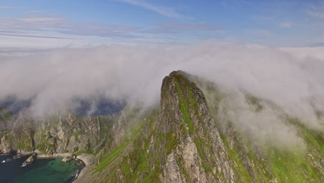 Stave-Norway-Aerial-v17-cinematic-drone-fly-towards-måtind-viewpoint-into-the-wilderness,-capturing-coastal-mountainscape-covered-in-thick-layer-of-dramatic-fog---Shot-with-Mavic-3-Cine---June-2022
