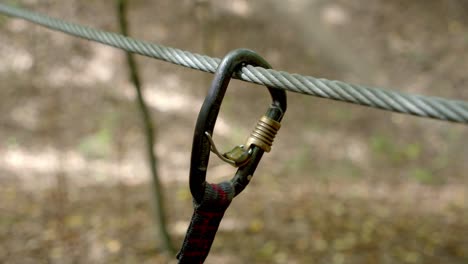 Hand-Puts-On-Auto-Lock-Carabiner-On-Wire-Rope
