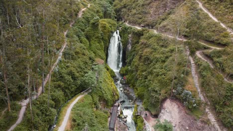 Aerial-View-Of-Peguche-Waterfall-In-Otavalo-With-Ascending-Dolly-Back-Reveal