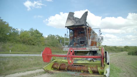 An-Old-Abandoned-Combine-Harvester-In-Rural-Field---close-up
