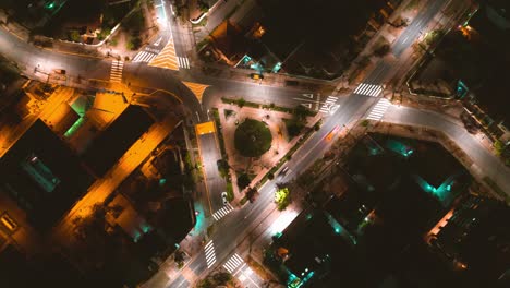 Aerial-time-lapse-of-a-triangle-shaped-intersection-where-vehicles-pass-leaving-a-trail-of-light-at-night