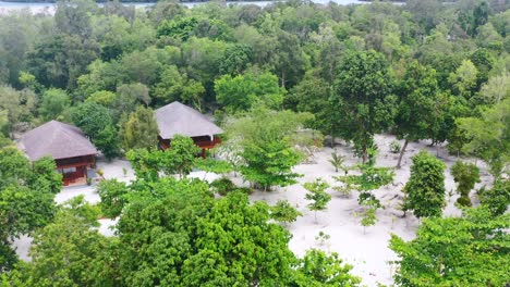 aerial-of-two-private-homes-on-Leebong-island-in-a-dense-forest-on-a-sunny-summer-day-Belitung-Indonesia