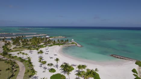 Aerial-view-around-a-empty-paradise-beach-in-Punta-cana,-Dominican-republic---circling,-drone-shot