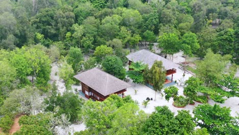 aerial-of-private-homes-on-Leebong-Island-in-Belitung-Indonesia-surrounded-by-dense-green-forest