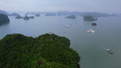 aerial-of-cruise-ships-traveling-through-Ha-Long-Bay-around-limestone-mountains-in-Vietnam