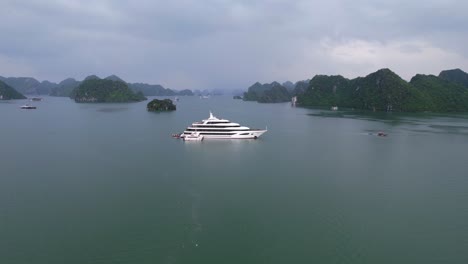 aerial-of-beautiful-white-luxury-yacht-anchored-in-Ha-Long-Bay-Vietnam-at-sunset