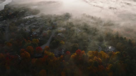 View-From-Above-Of-Clouds-Moving-Over-Fall-Foliage-In-Sherbrooke,-Quebec,-Canada-At-Sunrise