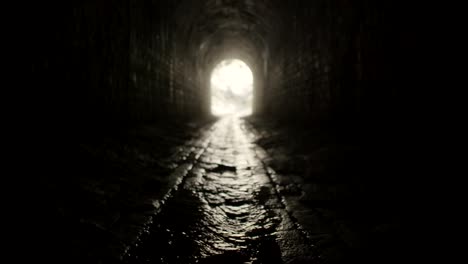 A-water-flowing-on-the-ground-of-a-dark-tunnel