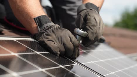 Technician-bolting-solar-panels-together-on-roof-for-sustainable-future