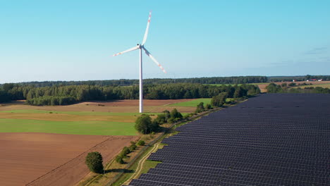 Luftaufnahme-Von-Sich-Drehenden-Windmühlen-Neben-Einer-Großen-Solaranlage