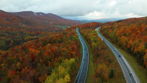 Stunning-aerial-flyover-shot-overlooking-the-Vermont-I-89-highway-in-the-midst-of-the-changing-colors-of-Autumn