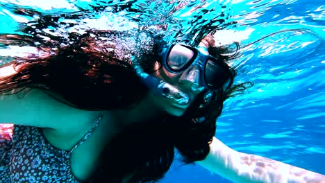 Woman-snorkeling-in-Zanzibar-with-googles-between-tropical-fishes-around
