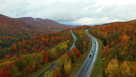 Gorgeous-drone-shot-looking-over-the-Vermont-I-89-highway-in-the-colorful-fall-foliage