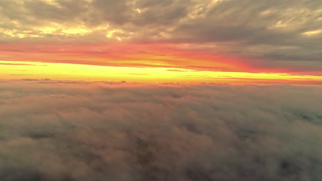 Aerial-sunset-view-of-yellow-horizon-above-cloud-inversion---weather-phenomenon
