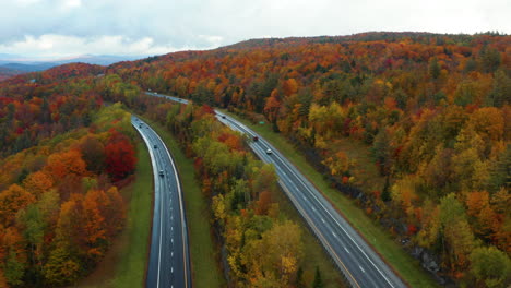 Oscillating-aerial-view-of-cars-travelling-down-the-Vermont-I-89-highway-in-the-Fall
