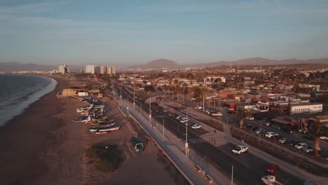 Flying-Over-Playa-Los-Pescadores-Beach-And-Beachfront-Avenue-In-Coquimbo,-Chile-At-Sunset