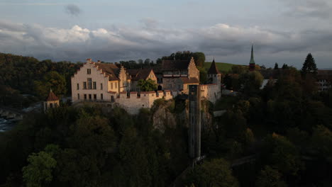 aerial-shot-in-orbit-over-the-castle-of-Laufen
which-is-located-on-the-mountain-near-the-falls-of-the-Rhine