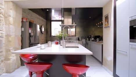 Slow-arcing-shot-of-a-luxury-kitchen-and-breakfast-bar