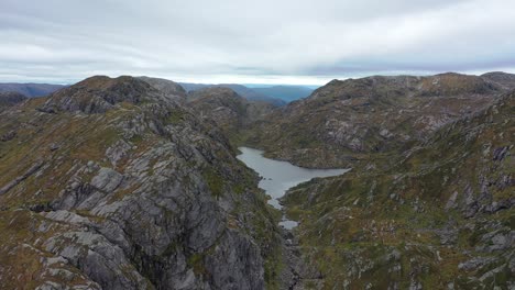 Aerial-showing-Krokavatnet-mountain-lake-close-to-knutstignova-peak-in-Vaksdal-Norway---Small-freshwater-lake-that-is-the-water-starting-point-for-hydroelectric-plant-Markaani