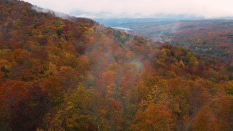 Low-hanging-clouds-fall-off-the-colorful-autumn-hills-in-New-England,-USA