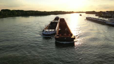 Ship-traffic-on-wide-river-at-sunset