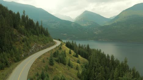 aerial-shot-of-Slocan-Lake-with-a-road-wrapping-around