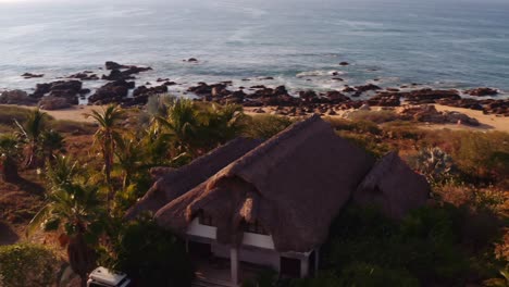 Fast-drone-pan-around-luxury-oceanfront-rental-villa-in-Oaxaca-Mexico-Pacific-Ocean-sunrise-4k-aerial