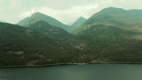 Aerial-dolly-left-exploring-Slocan-Lake-and-the-surrounding-mountains