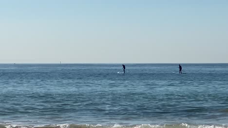 mans-paddling-on-a-stand-up-paddle-board-in-front-of-the-coast-of-Atlantic-ocean