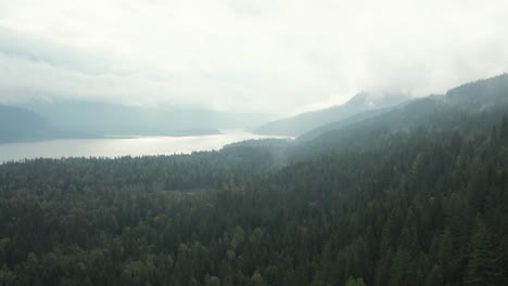 Slow-aerial-dolly-through-fog-showing-Upper-Arrow-Lake,-Canada