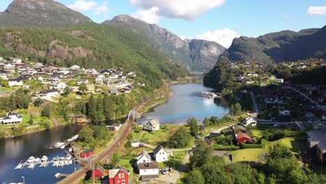 Dalevagen-fjord-with-marina-and-railroad-between-Bergen-and-Voss-seen-at-Stanghelle-Norway---Backward-moving-aerial