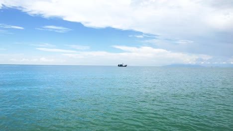 Fishing-Boat-Anchored-And-Floating-In-The-Ocean-In-The-Daytime