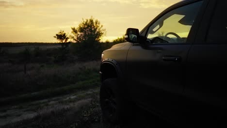 Pickup-Off-Road-Truck-Silhouetted-Static-at-Sunset---Revealing-shot
