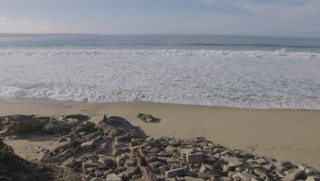 Slow-motion-shot-of-waves-crashing-onto-a-rocky-shoreline-of-southern-California