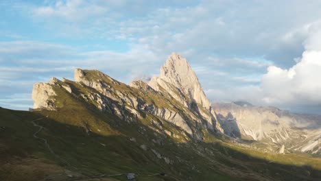 Orbit-drone-shot-of-top-of-a-mountains-in-a-sunny-morning-in-Dolomites,-Italy