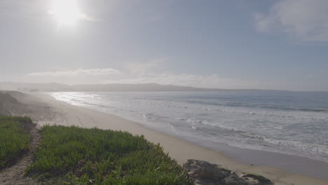 Slow-motion-shot-of-a-sunny-day-at-Monterey-Bay-California-Marina-State-Beach