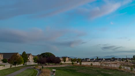Sunset-to-darkness-with-the-moon-rising-over-a-suburban-neighborhood---panoramic-motion-time-lapse