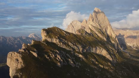 moving-foward-drone-shot-of-top-of-a-mountain-in-a-sunny-morning-in-Dolomites,-Italy