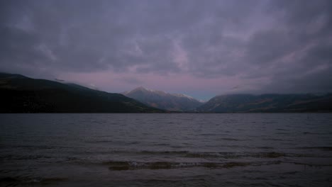 Dark-storm-clouds-and-pink-sky-over-the-Colorado-Rocky-Mountains-during-dawn-at-Twin-Lakes-Reservoir