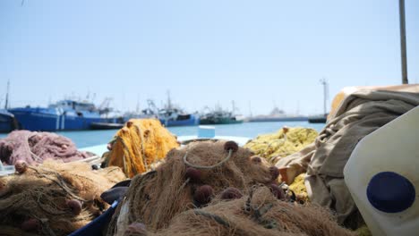 Fishing-nets-rest-on-the-deck-of-a-fishing-boat-on-a-sunny-day-in-the-marina