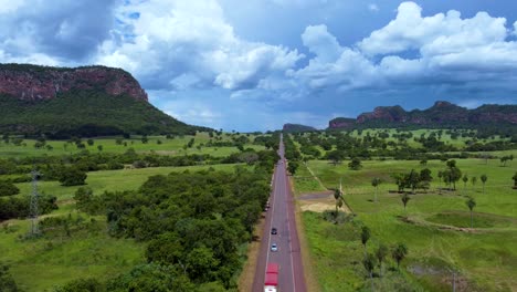 A-wide-road-in-the-middle-Pantanal,-the-Brazilian-cerrado-with-a-big-mountain